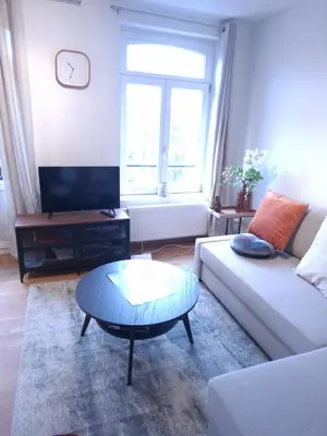 a living room with a couch and a coffee table at L'Horizon Saint-Lambert in Liège