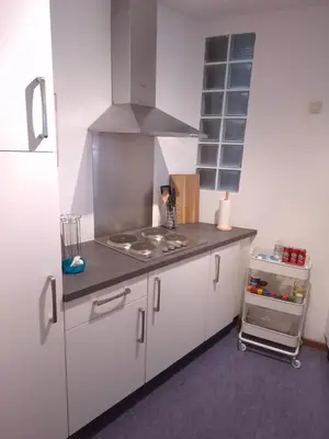 a kitchen with white cabinets and a stove top oven at L'Horizon Saint-Lambert in Liège