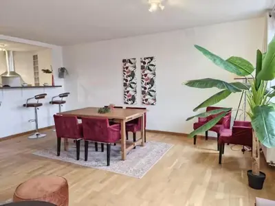 a dining room with a table and red chairs at L'Horizon Saint-Lambert in Liège