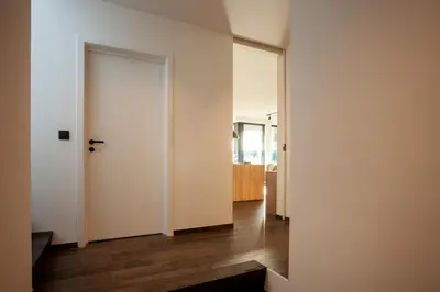 a hallway with white doors and wood floors at 8P 4B Luxury Villa Close to Maastricht in Lanaken