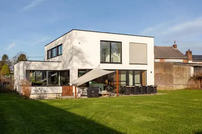 a white house with a slide in the yard at 8P 4B Luxury Villa Close to Maastricht in Lanaken