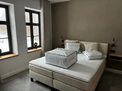 a bedroom with a bed with two pillows on it at Hidden Secret of Nature in Neeroeteren