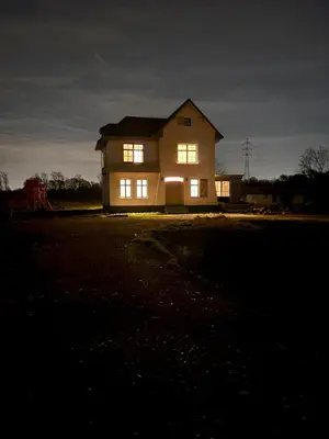 a house lit up at night with its lights on at Hidden Secret of Nature in Neeroeteren