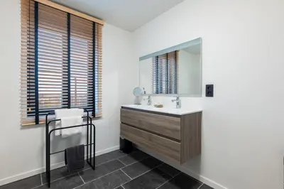 a bathroom with a sink and a mirror at Huys van Haeghe in Zoutleeuw