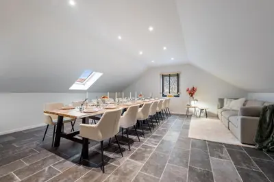 a dining room with a long table and chairs at Huys van Haeghe in Zoutleeuw