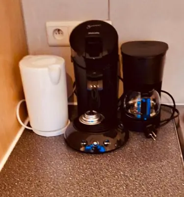 a coffee maker sitting on a counter next to a blender at Le Clémenty in Dison