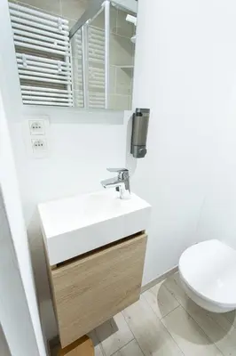 a bathroom with a sink and a toilet at Le Nid in Liège