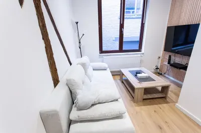 a living room with a couch and a coffee table at Le Nid in Liège