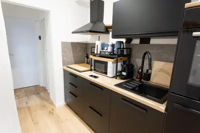 a kitchen with a sink and a microwave at Le Nid in Liège