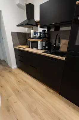 a kitchen with a sink and a microwave on a counter at Le Nid in Liège