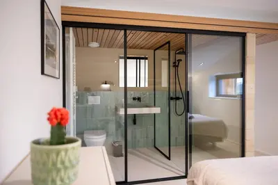 a bathroom with a glass shower and a toilet at Le Marzelheide 3 in Lontzen