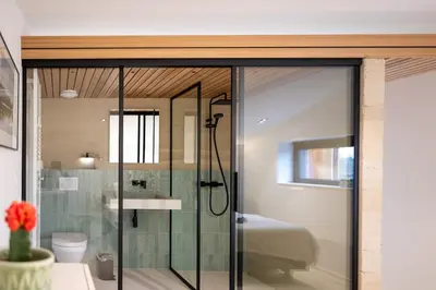 a bathroom with a glass shower and a sink at Le Marzelheide 3 in Lontzen