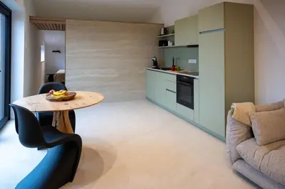 a small kitchen with a table and a couch at Le Marzelheide 3 in Lontzen