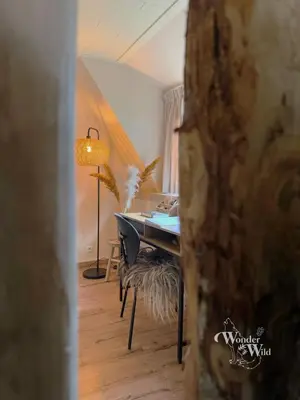 a room with a desk and a table with a lamp at Wonderwild E87, Connect to nature & Dog Friendly in Lanaken