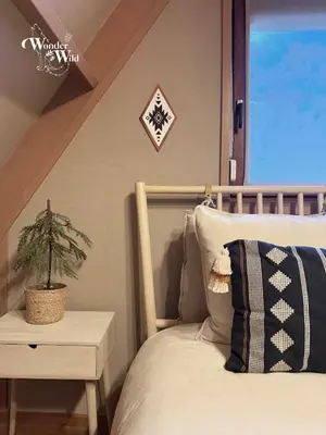 a bedroom with a bed and a plant on a table at Wonderwild E87, Connect to nature & Dog Friendly in Lanaken