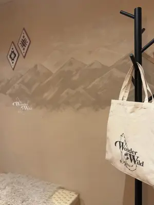a white bag hanging on a wall with a mountain mural at Wonderwild E87, Connect to nature & Dog Friendly in Lanaken