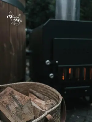 a basket of rocks in front of a fire at Wonderwild E87, Connect to nature & Dog Friendly in Lanaken