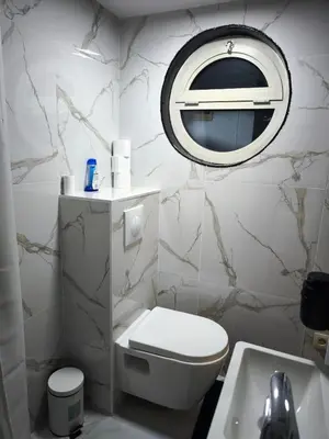 a white bathroom with a toilet and a mirror at Modern lux studio B in Beringen