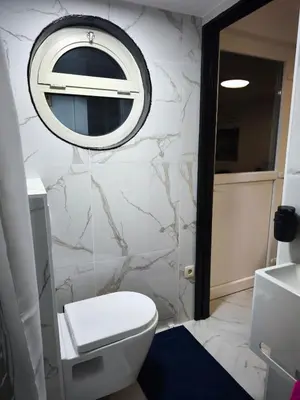 a bathroom with a white toilet and a mirror at Modern lux studio B in Beringen