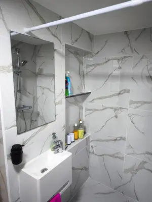 a white bathroom with a sink and a mirror at Modern lux studio B in Beringen