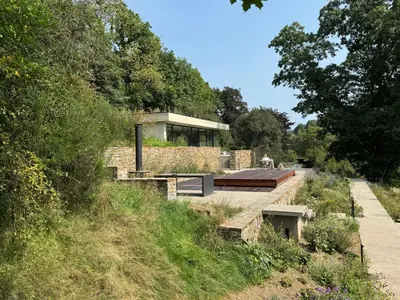 a house on the side of a hill at Homestorys Nature Resort - Lakeview Pavilion in Eupen