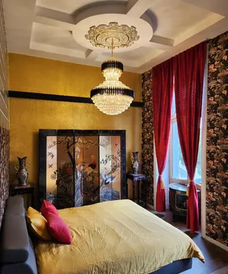 a bedroom with a bed and a chandelier at Kasteel Rosmeulen in Mall