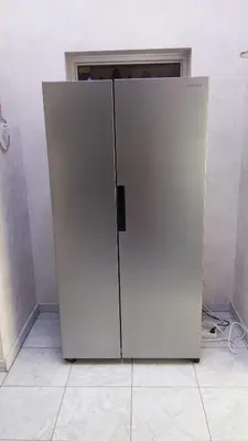 a large white refrigerator sitting in a room at logies Huis Liselotte in Genk