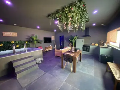 a large living room with a table and a kitchen at Your wellness break in Dalhem
