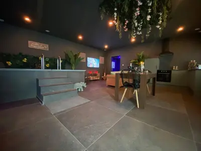 a living room with a table and a couch at Your wellness break in Dalhem