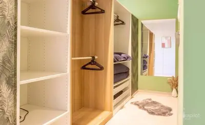 a walk in closet with shelves and a mirror at Charming 2-Bedroom House Rental in Dalhem, Belgium in Dalhem