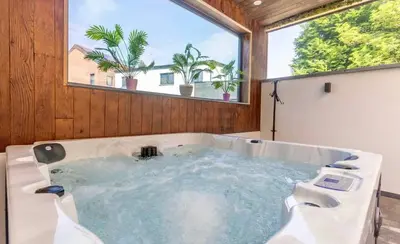 a large bath tub in a room with a window at Charming 2-Bedroom House Rental in Dalhem, Belgium in Dalhem