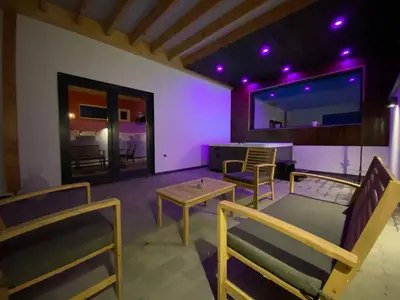 a living room with chairs and a table and a table at Charming 2-Bedroom House Rental in Dalhem, Belgium in Dalhem