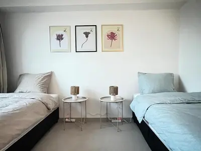 a bedroom with two twin beds and two tables at Casa Cielo-Spectacular View-Center-Chic-Spacious in Liège