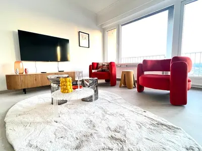 a living room with red chairs and a tv at Casa Cielo-Spectacular View-Center-Chic-Spacious in Liège