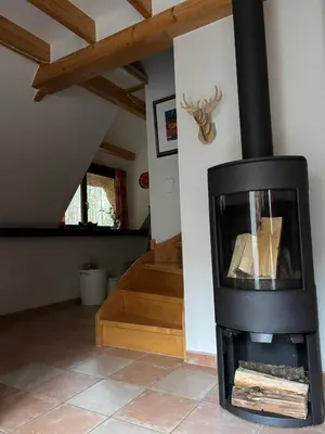 a fireplace in a living room with a staircase at Riet&Rust in Lanaken