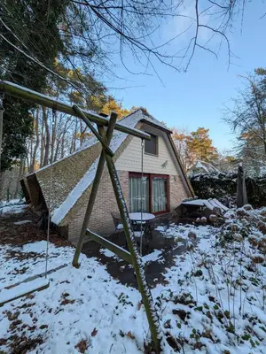 a pole in the snow in front of a house at Riet&Rust in Lanaken