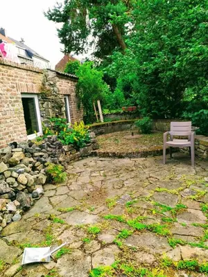 a bench sitting on a stone patio in a yard at Au coeur de l'Ardenne - Peaceful loft in Baelen