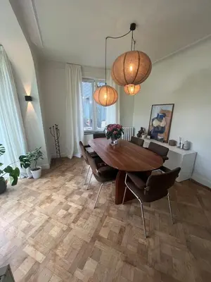 a dining room with a wooden table and chairs at House with garden for 4 people in Verviers