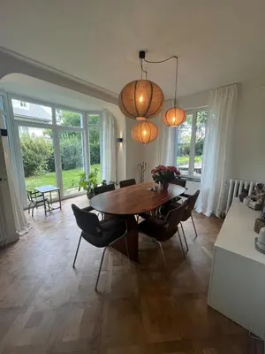 a dining room with a wooden table and chairs at House with garden for 4 people in Verviers
