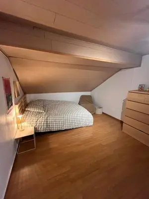 a bedroom with a bed and a wooden floor at House with garden for 4 people in Verviers