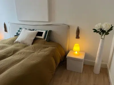 a bedroom with a bed and a vase with flowers at House with garden for 4 people in Verviers