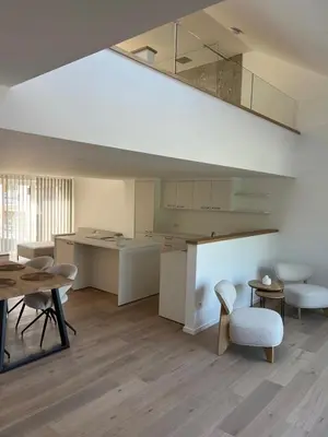 a room with a table and chairs and a kitchen at Atelier Cosy in Pepinster
