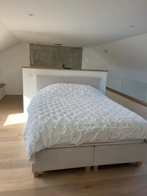 a bedroom with a white bed in a room at Atelier Cosy in Pepinster