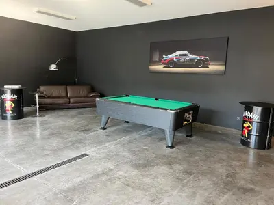 a living room with a pool table and a car on the wall at Atelier Cosy in Pepinster