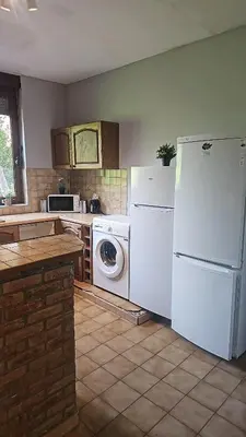 a kitchen with a white refrigerator and a washer at Charlemagne house in Liège