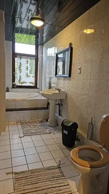 a bathroom with a toilet and a sink and a tub at Charlemagne house in Liège