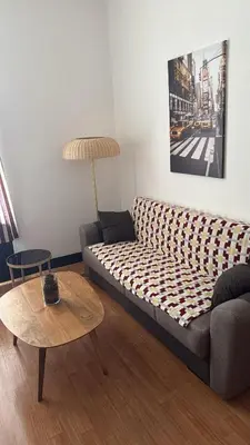 a living room with a couch and a table at Bayards 41 in Liège