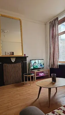 a living room with a mirror and a table at Bayards 41 in Liège