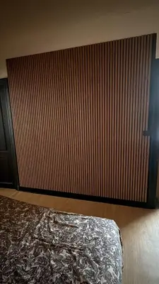 a bedroom with a large wooden wall and a bed at Bayards 41 in Liège