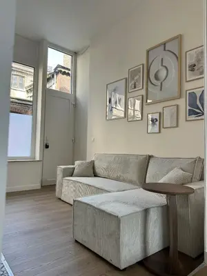 a living room with a couch and a table at Luik city center in Liège